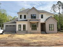 New two story home with gray and white accents, black window frames, and attached two car garage at 2633 Trifle Ln, Wake Forest, NC 27587