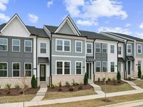 Charming new construction townhomes with gray and white exteriors and manicured landscaping at 814 Barlow Dr, Knightdale, NC 27545