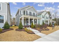 Charming two-story home with a welcoming front porch, manicured landscaping, and a well-maintained lawn at 1505 Patchings Ln, Knightdale, NC 27545