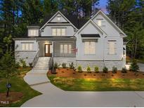 Charming home featuring stone accents, multiple windows, complemented by a professionally landscaped front yard at 3691 Graham Sherron Rd, Wake Forest, NC 27587