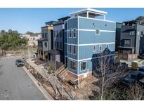 Striking three-story home featuring modern design and a rooftop terrace in a vibrant neighborhood at 618 Velma Hopkins Ln, Raleigh, NC 27603