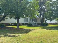 Charming single-story home with lush front lawn and mature shade trees at 1224 Greenbranch Ln, Raleigh, NC 27603