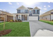 Two-story house with gray siding, white trim, and a large yard at 292 Chestnut Oak Ln, Lillington, NC 27546