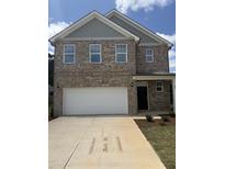 Charming brick two-story home features a large garage and well-manicured front yard at 401 Winding Creek Dr, Lillington, NC 27546