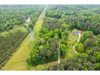 Secluded home site accessible via long driveway and surrounded by lush green trees, offering privacy and natural beauty at 2723 New Sharon Church Rd, Hillsborough, NC 27278