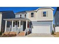 Two-story home with gray siding, red door, and a white garage door at 1341 Underbrush Dr, Durham, NC 27703