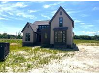 New construction home featuring a modern farmhouse design with a mix of siding and dark trim at 4905 Hidden Pasture Way, Zebulon, NC 27597