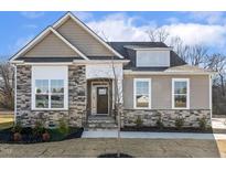 Craftsman style home with stone accents and a landscaped yard at 69 Browning Mill Dr, Wendell, NC 27591
