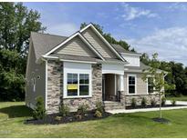 Charming single-Gathering home with stone accents, manicured lawn, and an 'available' sign at 69 Browning Mill Dr, Wendell, NC 27591