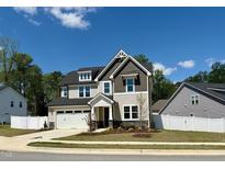 Charming two-story home with a two-car garage, manicured lawn and delightful curb appeal at 9113 Dupree Meadow Dr # 41, Angier, NC 27501