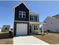 Charming two-story home boasts a two-car garage, attractive stone accents, and a welcoming covered front porch at 32 Furley St., Homesite 53, Sanford, NC 27330