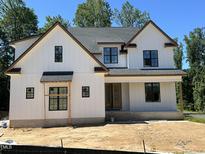 New construction: Charming two-story home featuring white siding, black-framed windows, and a welcoming front porch at 28 Bar Code Ct, Wendell, NC 27591