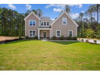 Charming two-story home with a manicured lawn and inviting curb appeal at 73 Artic Cir, Garner, NC 27529