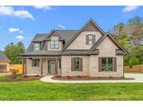Charming brick home with a manicured lawn and covered front porch, a welcoming entrance at 3402 St Barts Pl, Mebane, NC 27302