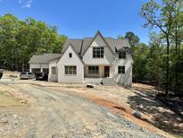 New construction exterior showcasing white painted brick, charming architectural details and a grey roof at 316 Firefly Overlook, Pittsboro, NC 27312