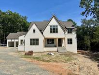 Striking two-story white brick home with gable roof and inviting front porch at 316 Firefly Overlook, Pittsboro, NC 27312