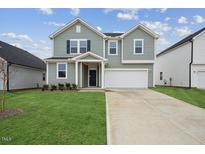 Charming two-story home with well-manicured lawn and neutral colored siding at 270 Chestnut Oak Ln, Lillington, NC 27546