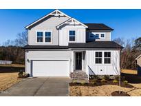 Two-story house with gray siding, white trim, and a two-car garage at 395 Fast Pitch Ln, Four Oaks, NC 27524