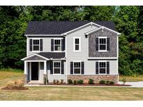 Charming two-story home with gray siding, black shutters, and a well-manicured front lawn at 427 Fast Pitch Ln, Four Oaks, NC 27524