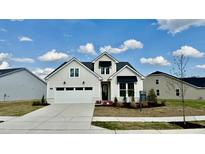 Beautifully designed exterior of a two-story home with white siding and a well-manicured lawn and black awnings at 2048 Abbeyhill Dr # 98, Raleigh, NC 27610
