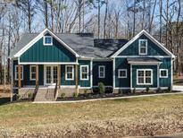 Craftsman style home with dark green siding, white trim, and a covered porch at 30 Tamaran Ct, Spring Hope, NC 27882