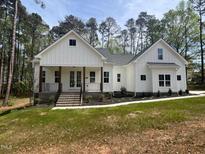 Charming single-Gathering home featuring a beautifully landscaped yard and inviting front porch at 30 Tamaran Ct, Spring Hope, NC 27882
