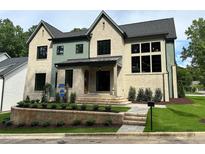 Stunning two-story brick home with a beautifully landscaped front yard and manicured lawn at 1000 Marilyn Dr, Raleigh, NC 27607