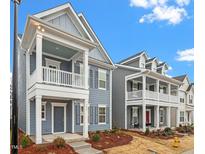 Gray two-story home with front porch and landscaping at 9228 Kitchin Farms Way # 412, Wake Forest, NC 27587