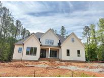 Charming new construction home with white siding, black trim, and a welcoming front porch at 155 Gaines Trl, Pittsboro, NC 27312