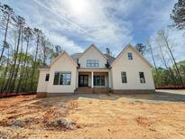 A charming single-Gathering home with a modern farmhouse exterior and craftsman-style details at 155 Gaines Trl, Pittsboro, NC 27312