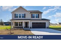 Charming two-story home with a covered front porch and attached two-car garage at 300 Tuscany Cir, Princeton, NC 27569