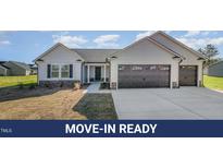 Charming single-story home with a three-car garage, neutral siding, and a well-maintained lawn at 102 Burnello Ct, Princeton, NC 27569