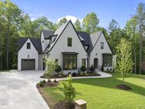 Stunning traditional two-story home with a well-manicured lawn and elegant landscaping at 7621 Falls Creek Ln, Raleigh, NC 27614