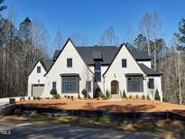 Stunning exterior of a new construction two-story home with a gray roof and modern design at 7621 Falls Creek Ln, Raleigh, NC 27614