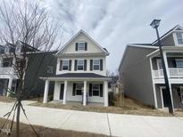 Charming two-story home with a welcoming front porch and classic architectural details at 9249 Kitchin Farms Way # 432, Wake Forest, NC 27587