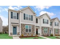 Charming two-story home with stone accents and a welcoming blue front door at 543 Old Battle Bridge Rd, Wendell, NC 27591