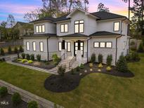 Stunning two-story home featuring stone accents, manicured lawn, and a grand entrance at 861 Wimbleton Dr, Raleigh, NC 27609