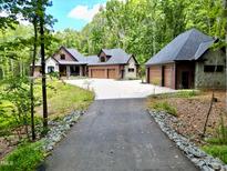 Brick home with three-car garage and landscaping at 1107 Westridge Rd, Rougemont, NC 27572