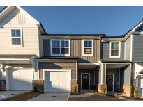 Charming townhome featuring a two-car garage and appealing exterior color scheme at 569 Marthas Vw Way, Wake Forest, NC 27587
