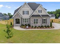 Beautiful new construction home featuring a landscaped yard and stone and shingle design at 25 Cotton Fields Ln # 29, Fuquay Varina, NC 27526
