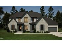 Two-story house with stone accents, dark gray shutters, and a three-car garage at 5428 Winding View Ln, Raleigh, NC 27615