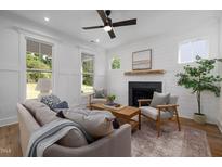 Modern kitchen with island, stainless steel appliances, and hardwood floors at 705 Heidelberg St, Durham, NC 27704