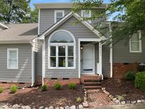 Charming home featuring a unique arched window and well-maintained landscaping at 1432 Quarter Pt, Raleigh, NC 27615