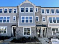 Three-story townhome with gray and stone exterior, offering modern curb appeal at 3006 Freewinds Way # 41, Cary, NC 27519