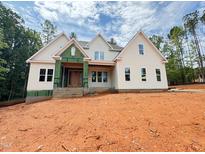 View of a charming new construction home featuring a modern exterior with large windows and a well-manicured lot at 111 Gaines Trail, Pittsboro, NC 27312