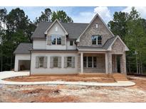 Charming two-story home with brick and siding, featuring a covered front porch and attached garage at 162 Gaines Trail, Pittsboro, NC 27312