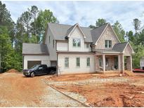 A beautiful two-story home with light brick and a large garage, set on a spacious lot at 162 Gaines Trail, Pittsboro, NC 27312
