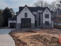 Modern two-story home with vertical siding and black accents is under construction at 5812 Shawood Dr, Raleigh, NC 27609