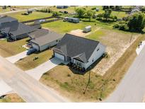 An aerial view of a home with a long driveway in a neighborhood at 87 S Cousins Ct, Smithfield, NC 27577
