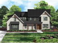 Beautiful modern two-story home with brick, dark accents, professional landscaping, and a welcoming front porch at 139 Goodison Park Rd, New Hill, NC 27562